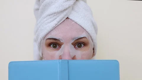 Millennial woman doing face procedures,applying under eye patches Stock-Footage 242990272