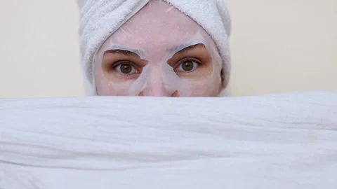 Millennial woman doing face procedures,applying under eye patches Stock-Footage 242990288