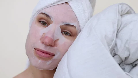 Millennial woman doing face procedures,applying under eye patches Stock-Footage 242990293