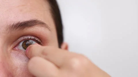 Millennial woman put or remove contact lens Stock Footage 247173420
