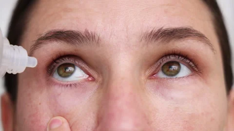 Millennial woman put or remove contact lens Stock Footage 247173493