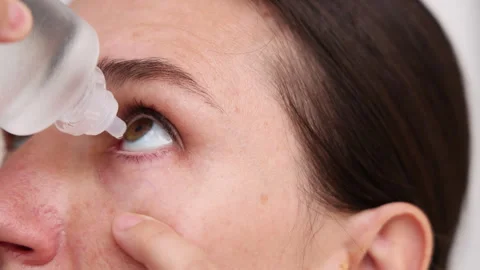 Millennial woman put or remove contact lens Stock Footage 247173556