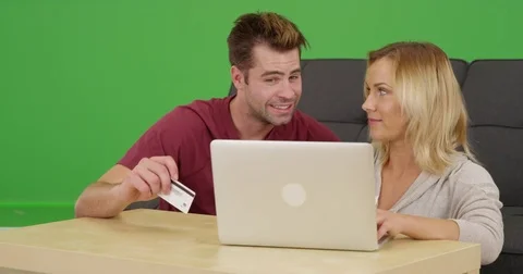 Millennials online shopping together on laptop on green screen Stock Footage