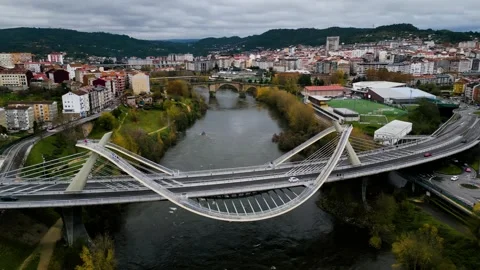 Millennium Bridge Miño River in Ourense, Galicia, Spain with Roman bridge Stock Footage 259616678
