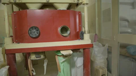 A miller checking the operation of a mechanical industrial mill and working Stock Footage 173473421