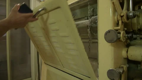 A miller checking the operation of a mechanical industrial mill and working Stock Footage 173474020