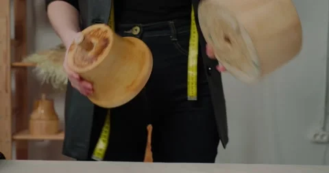 Milliner puts wooden mold on table to pull felt body Stock Footage 207458625