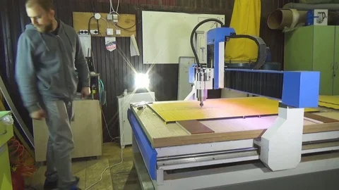 Milling cnc cuts the plastic panel by executing the cnc program. The worker Stock Footage 76450662