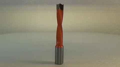 Milling cutter and router bit. Long four flute orange dowel drill. Stock Footage
