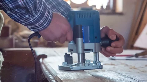 Milling cutter electric on a tree close-up, sawdust flying in the sides Stockbeeldmateriaal 84520087