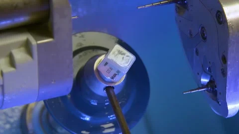 The milling machine cuts the ceramic dental crown from the workpiece. Stock Footage 256581068
