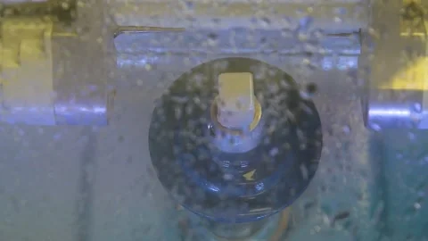 The milling machine cuts the ceramic dental crown from the workpiece. Stock Footage 256581125
