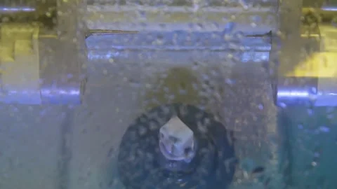 The milling machine cuts the ceramic dental crown from the workpiece. Stock Footage 256582756