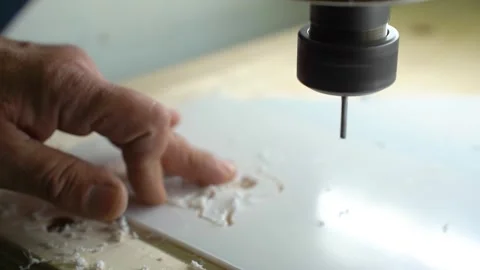 A milling machine cuts letters out of a plastic sheet. Stock Footage 286972712