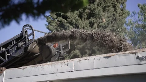 Milling machine depositing asphalt aggregate into truck for road repair material Video stock 332615417