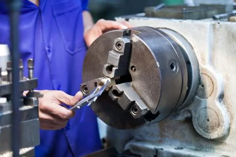 Milling machine operator working in factory workshop Stock Photos