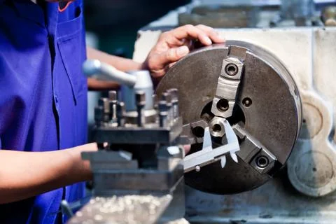 Milling machine operator working in factory workshop Stock Photos