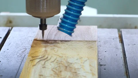 Milling machine tool cuts out a pattern in a plank Stock Footage 120596644