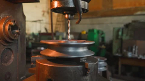 Milling machine tool makes hole in round detail in workshop Stock Footage 243306388