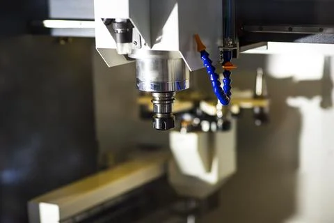Milling machine tool with mill in chuck preparing to process metal detail at  Stock Photos