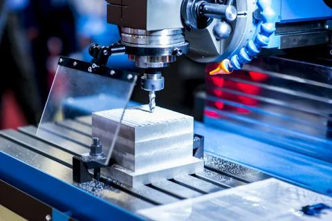 Milling machine tool with mill in chuck preparing to process metal detail at  Stock Photos