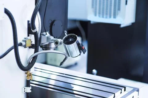 Milling machine tool with mill in chuck preparing to process metal detail at  Stock Photos