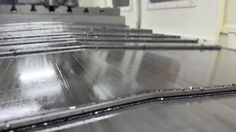 Milling machine worktable in action: sturdy metal surface with T-slots grips  Stock Footage 325649358