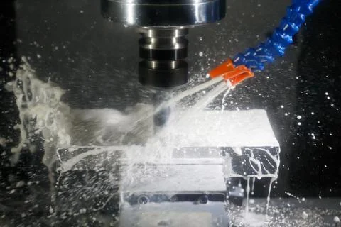 Milling process with coolant on a CNC machine Stock Photos