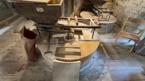 Millstone in action stone grinding grain spelt in an old mill for flour pro.. Stock Footage 314727407