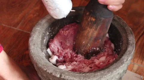 Millstone pounding meat, making daily dish Stock Footage 49709117