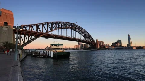 Milsons Point ferry wharf on Sydney harbour at sunset under the bridge. Stock Footage 135306924