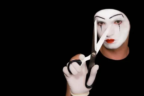 Mime with scissors on  black background Stock Photos