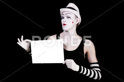 Mime in striped gloves and white hat holding white blank Stock Photos
