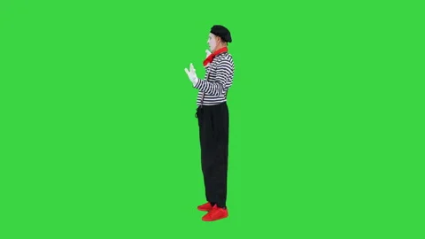 Mime walking through the imaginary door on a Green Screen, Chroma Key. Stock-Footage 139014446
