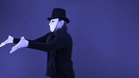 Mime in a white mask-face, hat and white gloves dancing plastically Stock Footage 142539746