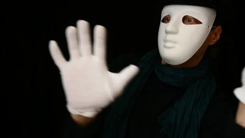 Mime in a white mask-face, hat and white gloves dancing plastically Stock Footage 142720992