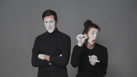 Mimes playing boyfriend waiting while his girlfriend doing makeup. Mime actor Stock Footage 99636627