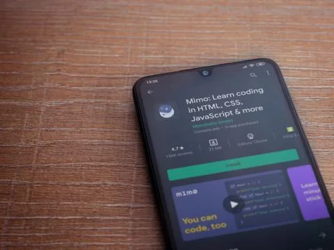 Mimo - Learning coding app play store page on the display of a black mobile s Stock Photos