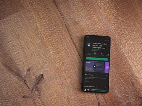 Mimo - Learning coding app play store page on the display of a black mobile s Stock Photos