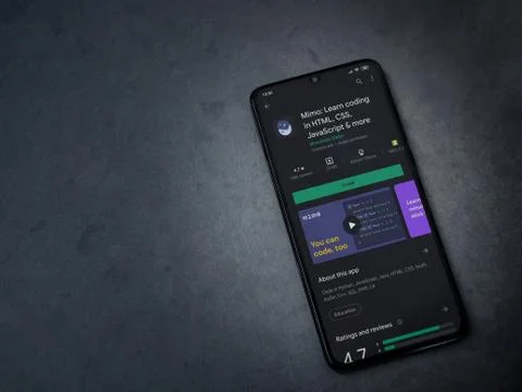 Mimo - Learning coding app play store page on the display of a black mobile s Stock Photos