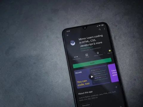 Mimo - Learning coding app play store page on the display of a black mobile s Foto stock
