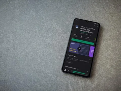 Mimo - Learning coding app play store page on the display of a black mobile s Stock Photos