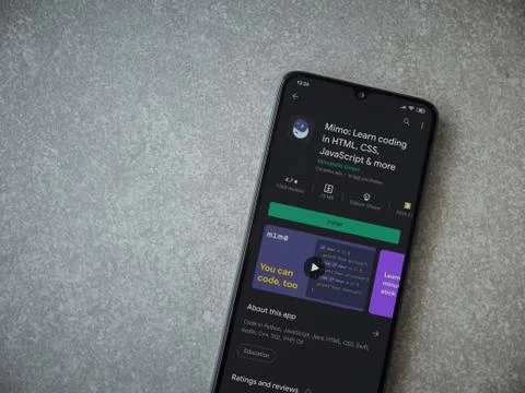 Mimo - Learning coding app play store page on the display of a black mobile s Stock Photos