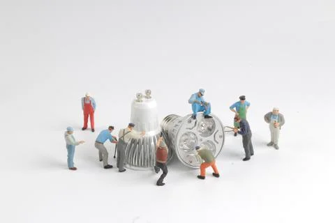 Min worker with pickaxe working on a sparkplug Stock Photos