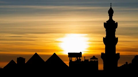 Minaret of Sultan Hassan Mosque with Pyramids of Giza in background Cairo, Egypt Stock Footage 108766607