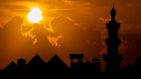 Minaret of Sultan Hassan Mosque with Pyramids in background, Cairo, Egypt Stock Footage 108766650