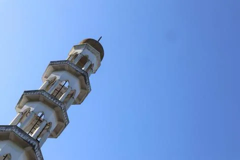 Minaret's Ascendance A low angle view of a mosque's tall minaret Stock Photos