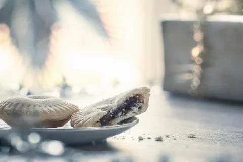 Mince pies with missing bite on plate Stock Photos