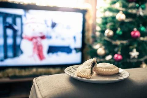 Mince pies with missing bite on plate Foto stock
