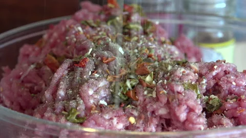 Minced Meat being made in the shredder and adding spices Stock Footage 239675427